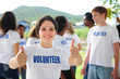 happy volunteer girl showing thumbs up sign