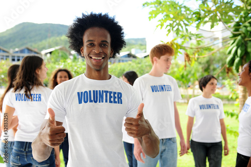 Photo: happy volunteer african american man showing thumbs up sign happy volunteer african american man showing thumbs up sign