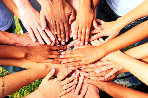 Foto: many hands together: group of people joining hands many hands together: group of people joining hands