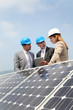 Engineers checking solar panels setup Engineers checking solar panels setup
