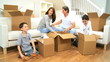 Young Caucasian Family Unpacking in New Home