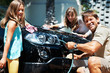 Family washing car and smiling