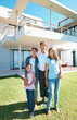 Happy family of four in front of home Happy family of four in front of home