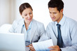 Confident business colleagues working together at office desk