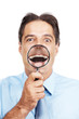 Mature business man with magnifier glass in front of his mouth Mature business man with magnifier glass in front of his mouth