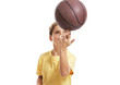 Sweet little child balancing basketball on fingers