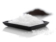 Sea salt in square bowl over white background