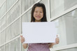 Beautiful businesswoman with blank paper for advertisement