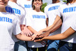 multi-ethnic volunteer group hands together