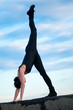 dancing woman over blue sky. Yoga