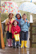 Photo: Children posing with umbrella Children posing with umbrella