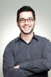 Portrait of young casual man with glasses smiling