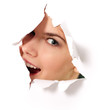cheerful teen girl peeping surprised through hole in paper