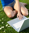 Woman in park working with laptop