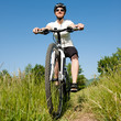 Young girl riding a bike on a field path - offroad