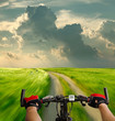 Foto: Man with bicycle riding country road Man with bicycle riding country road