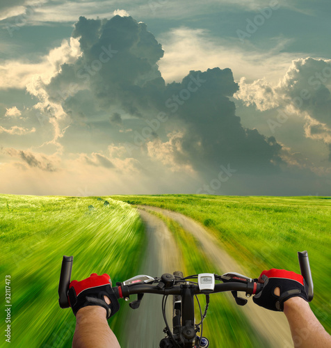 Photo: Man with bicycle riding country road Man with bicycle riding country road