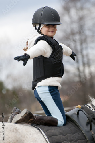 Photo: Horse riding - little girl stunt riding Horse riding - little girl stunt riding
