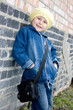 Girl at the brick wall.