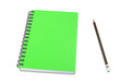 Green notebook and pencils isolated on white background
