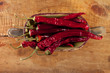 dried red hot chillies pepper in old wooden bowl, shallow dof dried red hot chillies pepper in old wooden bowl, shallow dof
