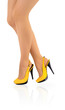 Beautiful ladies legs in yellow high heels Beautiful ladies legs in yellow high heels