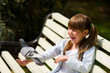 girl feeding Pigeon