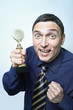 Young man in tie being crazy happy holding golden trophy