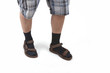 man wearing sandals with socks and having hairy legs.