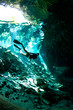 Free diver at an entrance to Cenote