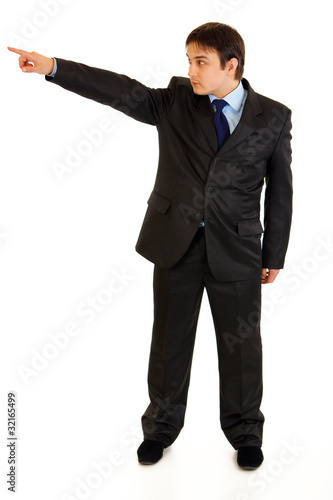 Photo: Confident businessman pointing in corner isolated on white. Confident businessman pointing in corner isolated on white.