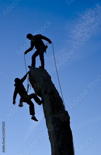 Photo: Team of climbers reaching the summit. Team of climbers reaching the summit.