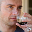 Homme dégustant un verre de vin rouge