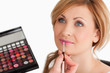 Cute female having her make up done by a make up artist
