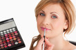 Young female having her make up done by a make up artist
