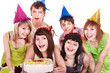 Group of happy young people with cake.