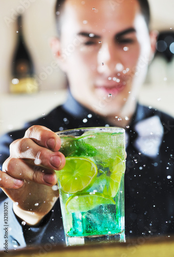 Photo: pro barman prepare coctail drink on party pro barman prepare coctail drink on party