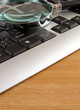 magnifier and laptop with on wood