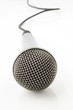 Silver microphone with black wire on white Silver microphone with black wire on white