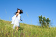 beautiful girl in white dress in a meadow