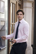A businessman using a cash machine