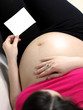 Pregnant woman sittig in bed