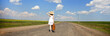 Lonely girl with suitcase at country road. Panoramic photo. Lonely girl with suitcase at country road. Panoramic photo.