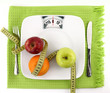 Fruits with measuring tape on a plate like weight scale Fruits with measuring tape on a plate like weight scale