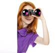 Teen redhead girl with binoculars isolated on white background