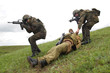 Soldiers saving their wounded partner Soldiers saving their wounded partner