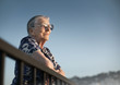 Photo: Senior woman looking forward over blue sky Senior woman looking forward over blue sky