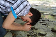 Photo: Man Praying by Creek Man Praying by Creek