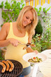 Photo: Junge Frau beim Grillen Junge Frau beim Grillen