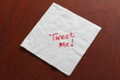 Tweet Me written on a used Napkin